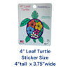 Colorful tropical floral sea turtle sticker with purple shell, pink yellow blue and white flowers, green leaf flippers, 4 inches tall by 3.75 inches wide
