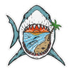 Paradise Shark die-cut vinyl sticker featuring a blue great white shark with an open mouth framing a colorful tropical sunset, ocean waves, sandy beach, and green palm tree.
